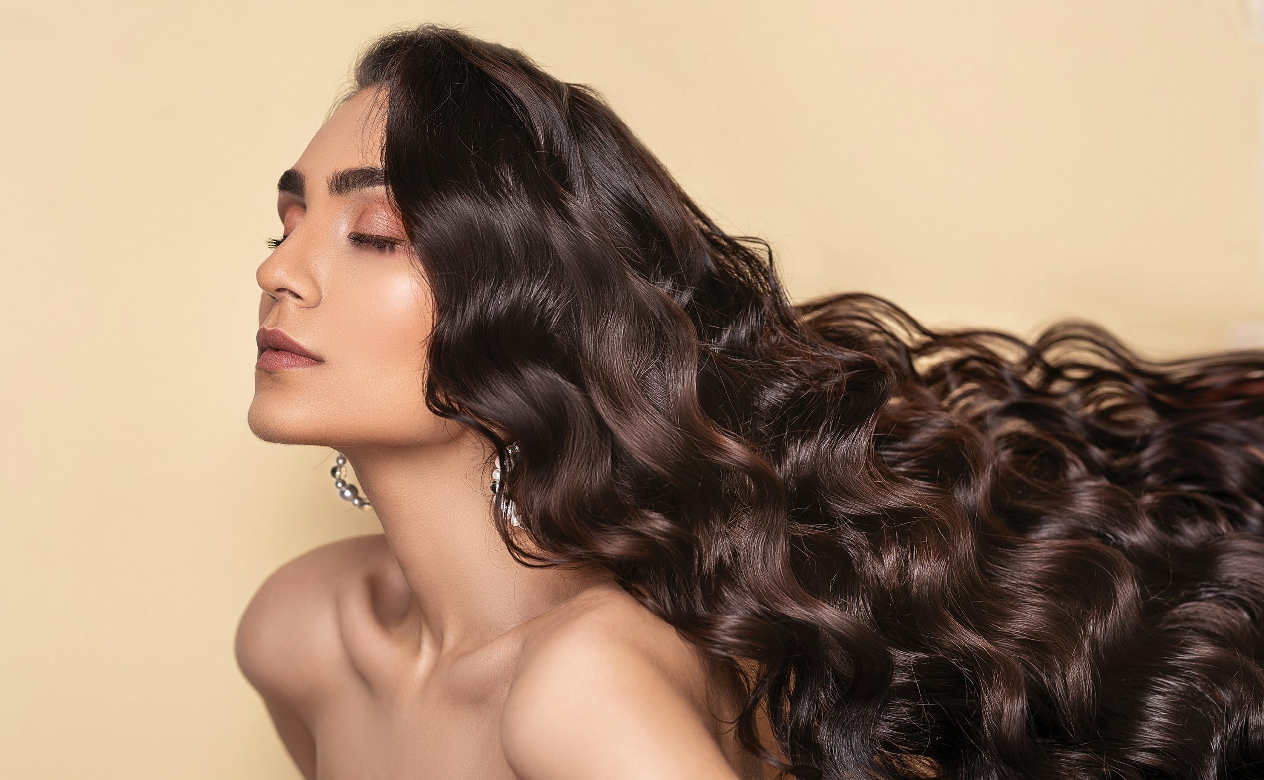Soft, romantic curls on long brown hair – elegant styling by hair experts in Paarl