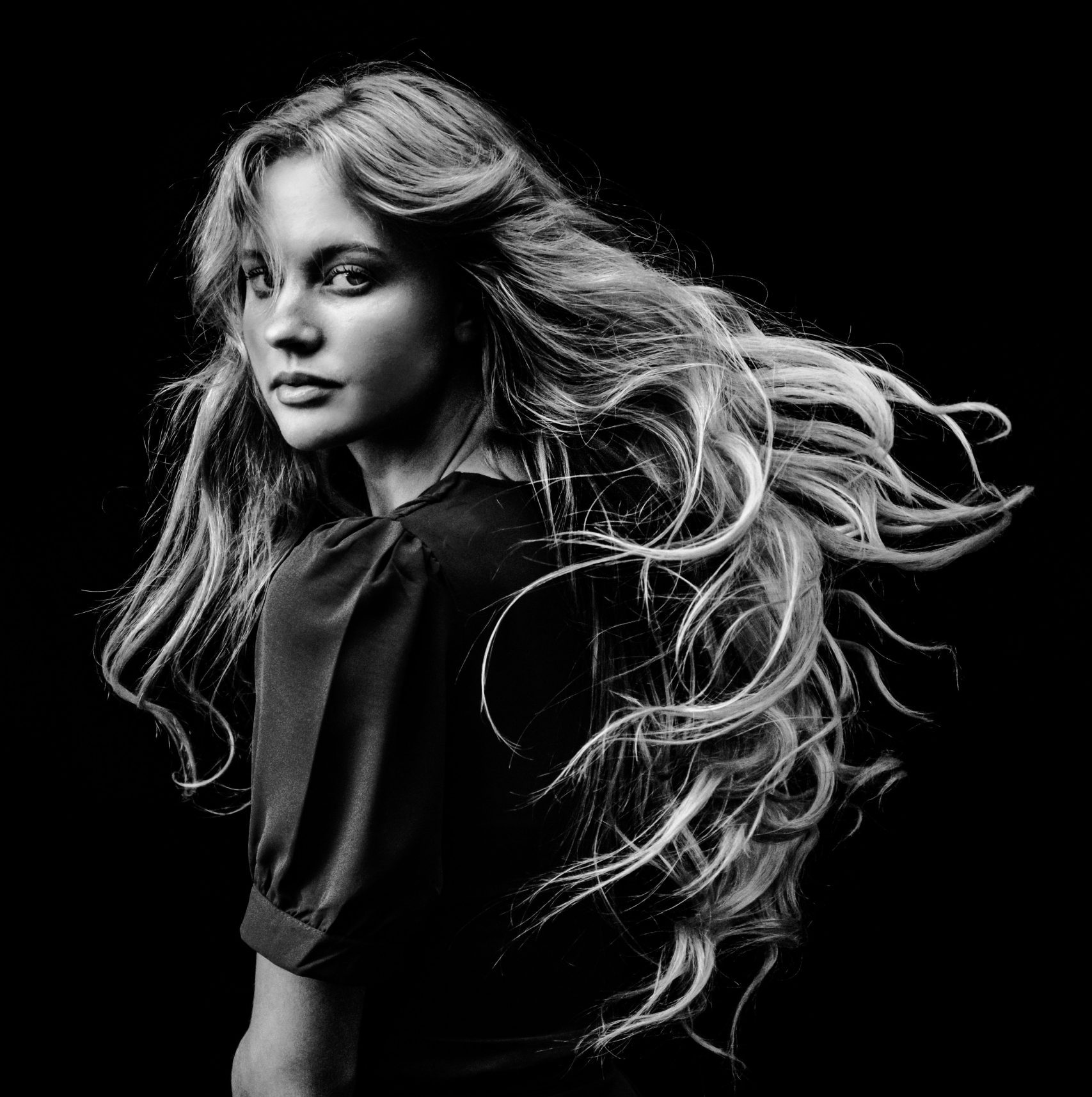 Woman flipping long healthy hair – hair care and styling in Paarl and Wellington