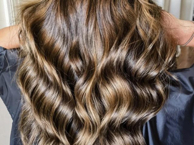 Back view of styled hair with soft curls – premium women’s hair salon in Paarl