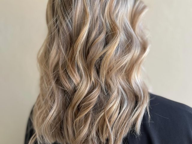 Back view of styled hair with soft curls – premium women’s hair salon in Paarl