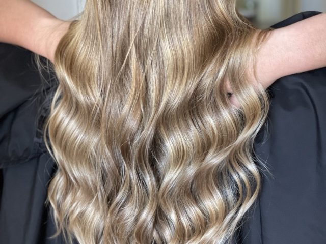 Back view of styled hair with soft curls – premium women’s hair salon in Paarl