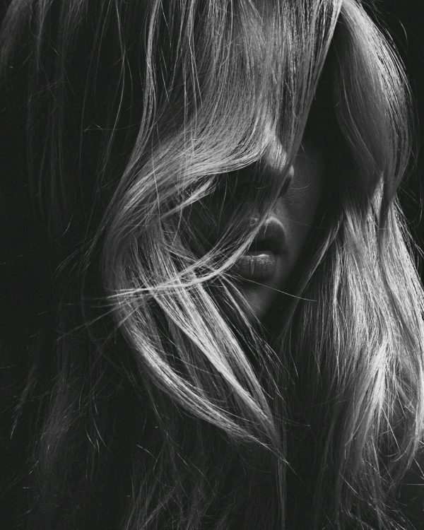 Blonde woman with soft waves – balayage and styling by hair professionals in Paarl